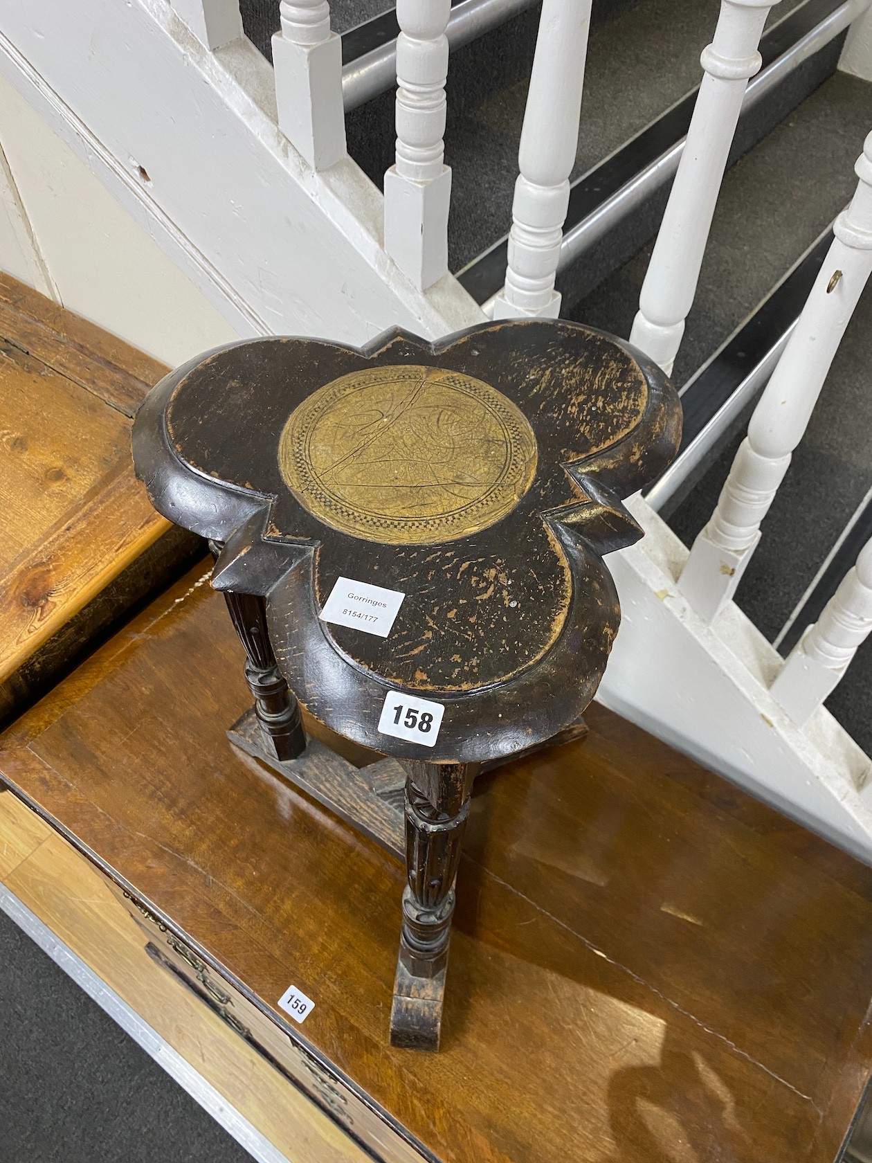 An unusual carved oak trefoil occasional table, width 36cm, height 58cm